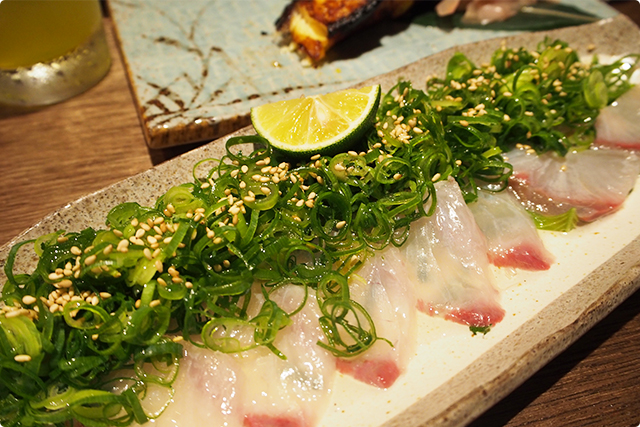 Pickled Greater amberjack carpaccio with local green onion and Sudachi (Japanese citrus)