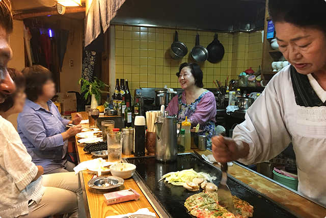 Chatting with the local customers while mama is preparing the food.